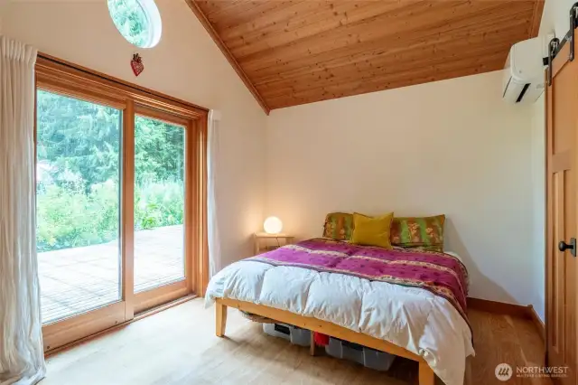 Main floor bedroom with French doors that lead you to the deck and gardens