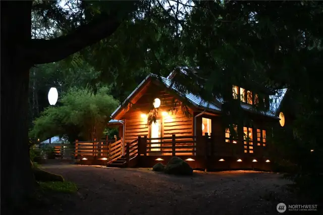 Surrounding lights for visibility along with landscape lighting that highlights the beauty of the surrounding trees.