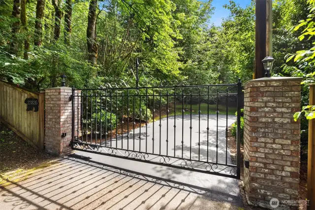 Beautiful entrance with automatic gate and lush grounds.