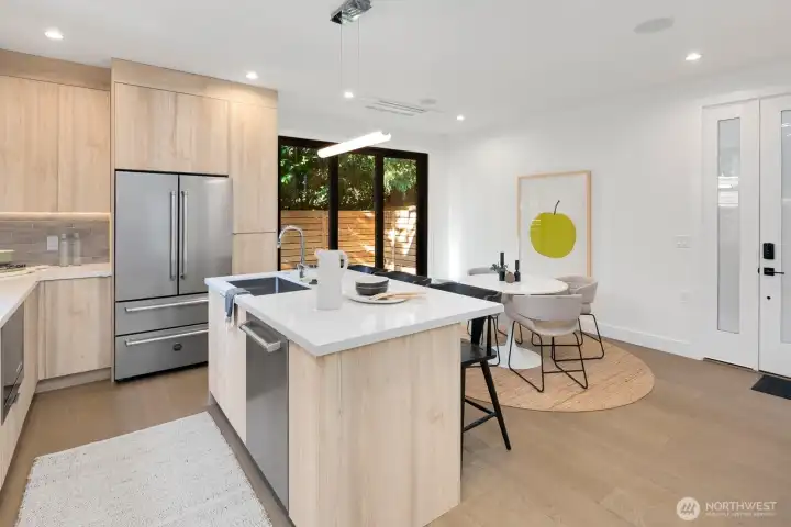 The main entrance is the door on the right. There is a recessed minisplit. The sliding glass "wall" takes you to a private, fenced backyard with patio.