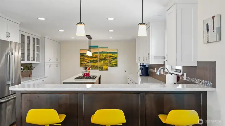 The spacious chef's kitchen features Bosch appliances, a natural gas cooktop and gorgeous solid surface white countertops.