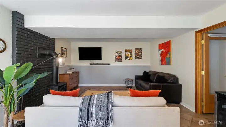 Easy to maintain tile flooring and black out shades on the French doors also make this a great space for overnight guests or even a second primary bedroom.