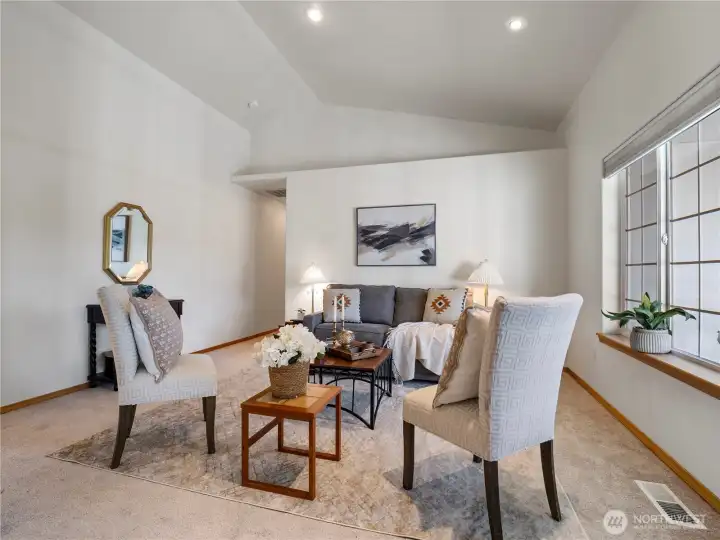 The living room has vaulted ceilings and architectural details to welcome you in.