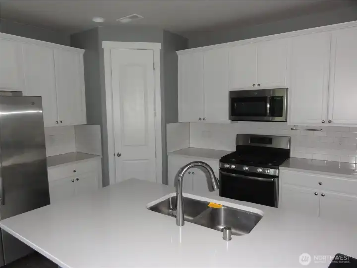 Eating bar in kitchen. Gas appliances.