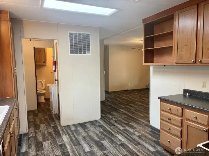 Kitchen looking into laundry room bathroom door open