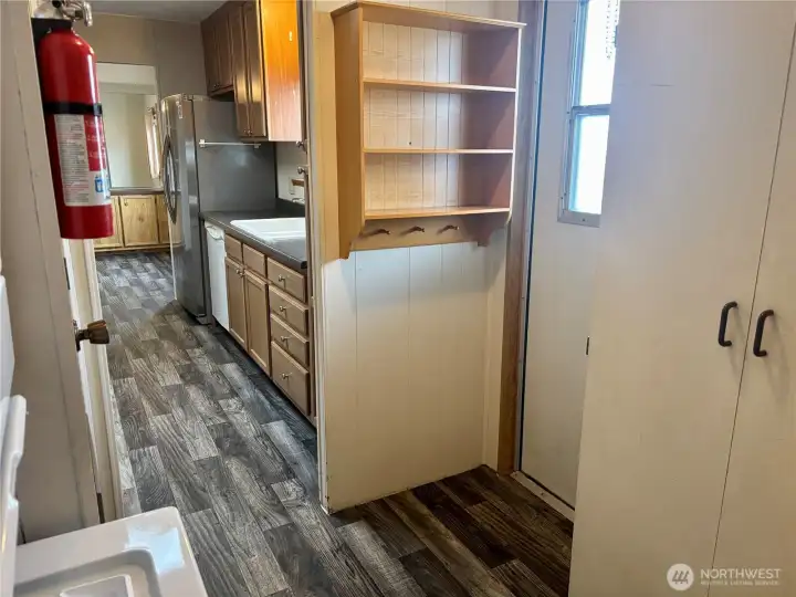 Looking out from bathroom, back door to the right. Kitchen straight ahead.