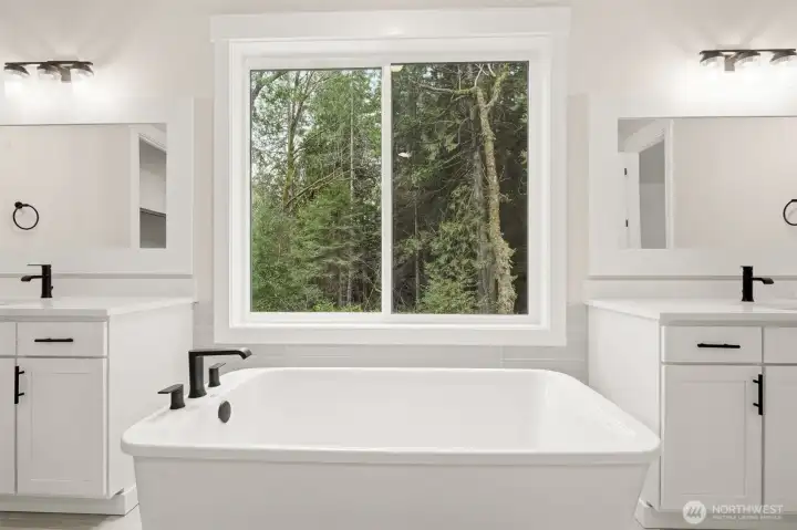 Large soaking tub with views into forest owned by St. Martins University