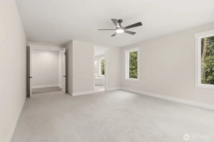 Main floor primaty bedroom with sliding door to patio and hot tub pad