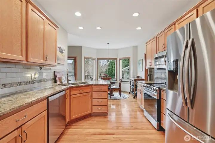 Kitchen with granite countertops and newer stainless steel appliances.