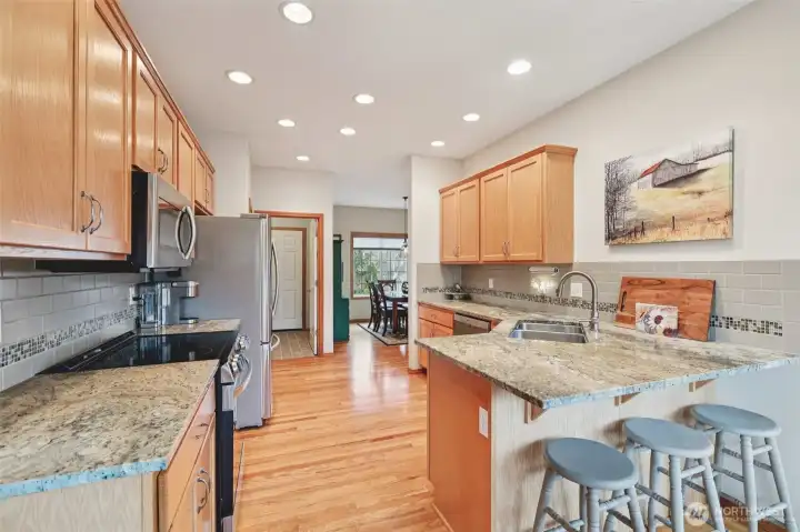 Functional kitchen layout with generous workspace and storage. Dining area conveniently located next to the kitchen.