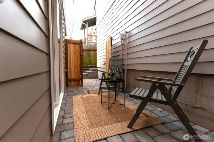 Patio outside main floor bedroom with gated access from walkway