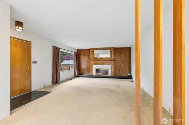 Large living room with gas fireplace welcomes you inside.