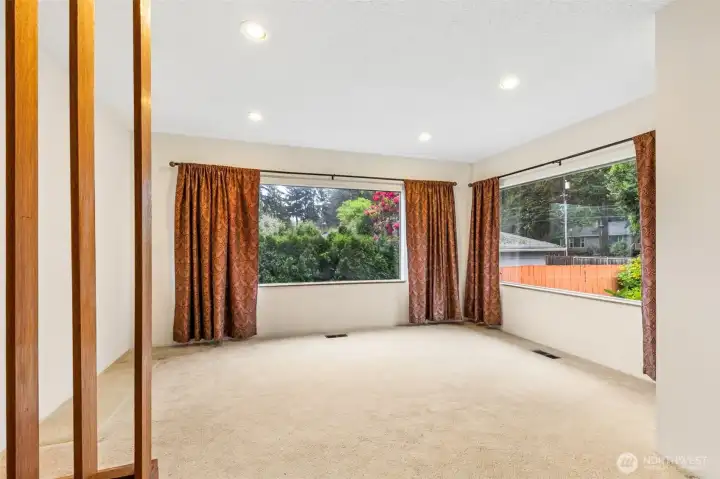 Formal dining room with two large picture windows.