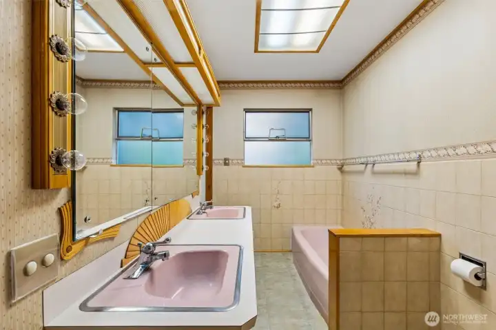 Jack and Jill style full bath opens to primary bedroom and main floor.