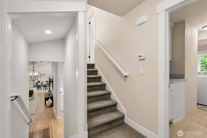 Upper landing with staircase access to the main level and secondary bedrooms. Upper landing with staircase access to the main level and secondary bedrooms.