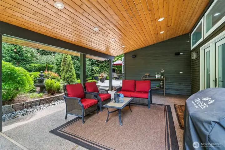Covered outdoor living area with rich wood ceiling detail, recessed lighting, and plenty of space to gather year round. Covered outdoor living area with rich wood ceiling detail, recessed lighting, and plenty of space to gather year round.
