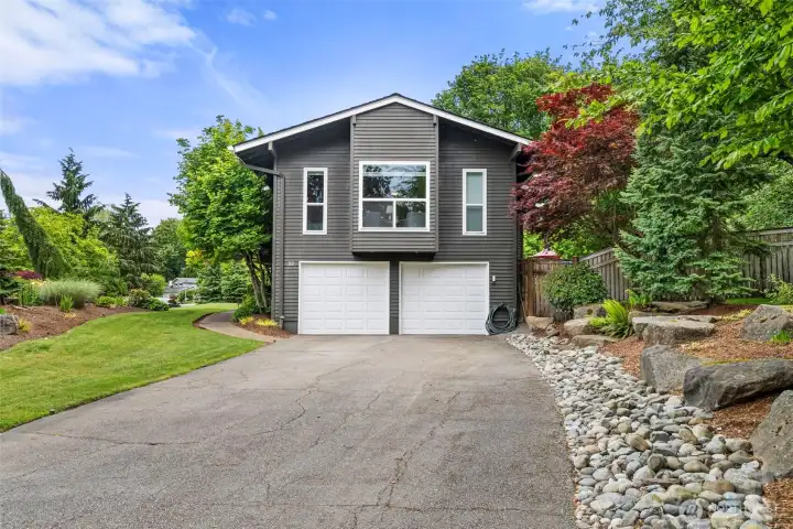 Expansive driveway with oversized two car garage and beautifully landscaped grounds. Expansive driveway with oversized two car garage and beautifully landscaped grounds.