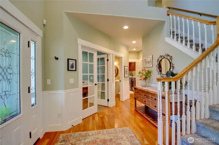 Welcoming entry, looking toward the Den, 1/2 bath, and hall to laundry room