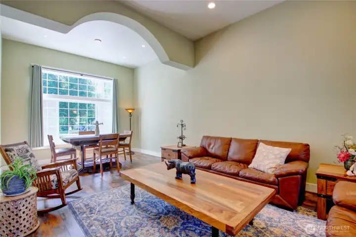 Living room #1 (of2) and dining room, note the large picture window facing the back yard and gorgeous LVP flooring