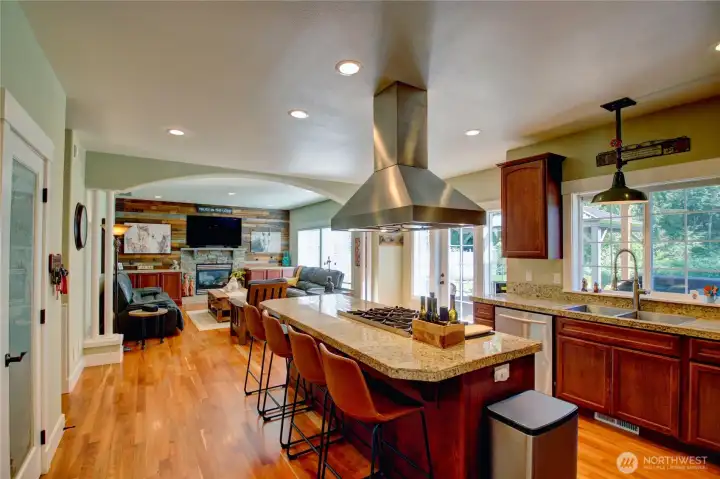 Chefs dream kitchen with 6 burner gas Wolf range, double sized built-in refrigerator/freezer, wine cooler, granite countertops, hardwood floors and an abundance of beautiful cabinetry. Kitchen faces the incredible back patio and yard area.