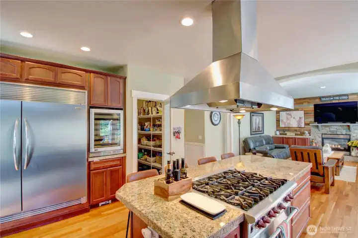 Chefs dream kitchen with 6 burner gas Wolf range, double sized built-in refrigerator/freezer, wine cooler, granite countertops, hardwood floors and an abundance of beautiful cabinetry. Kitchen faces the incredible back patio and yard area.
