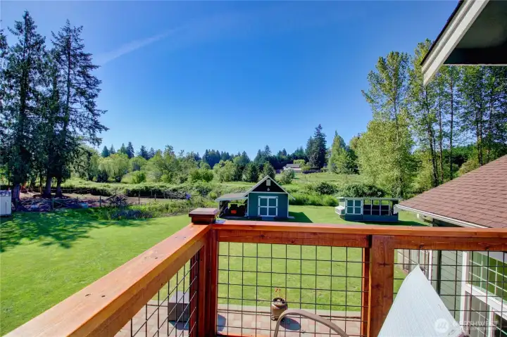 Deck off the Primary Suite overlooks the entire back portion of the 7 acres.