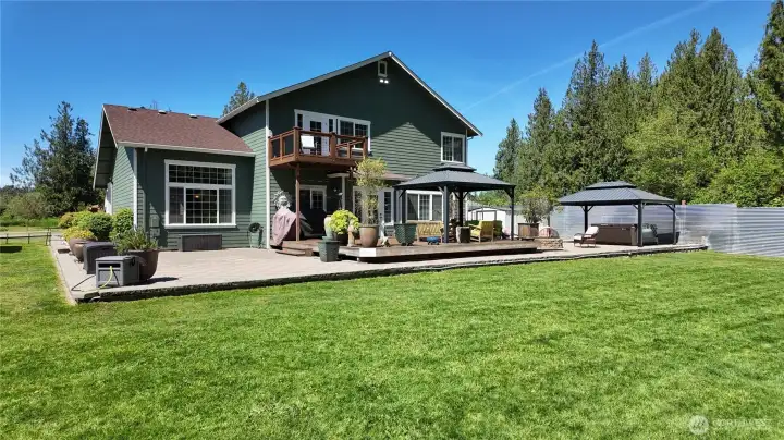 Incredible back deck/patio with 2 covered gazebos, spa tub, fire pit, and privacy galore!