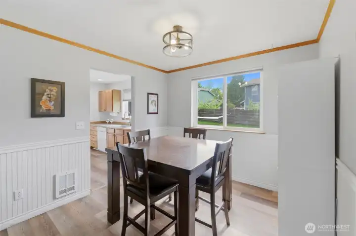 Bright dining space with beadboard detail, adjacent to the kitchen