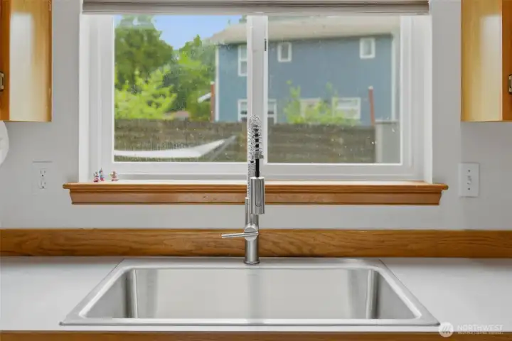 A perfect view across your new deep sink into the fenced backyard space.