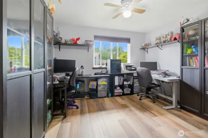 Bedroom 2, used as a shared computer space, features updated easy-care flooring.