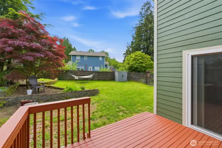 Deck is just off the kitchen, and leads into the fenced backyard area.