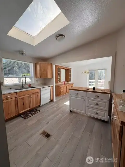 Updated kitchen with mobile island that has a beautiful butcher block top
