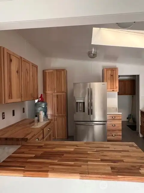 Laundry room/mud room is to the right of the refrigerator