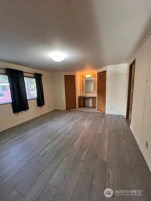 Primary suite with vanity & his/her closets on each side