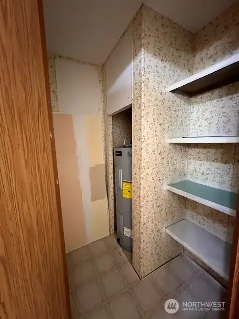 Storage room in primary bath with new electric 50 gallon water heater