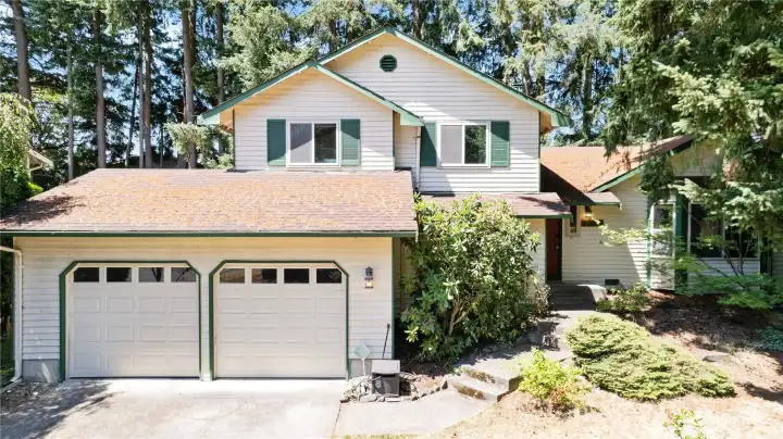 Welcome to this very Pacific Northwest home with mature landscaping, 2 car garage tucked back a bit from road