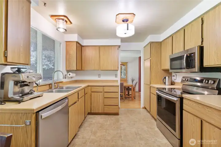 Kitchen is original but clean and open. Plenty of lighting, updated appliances with tile floors