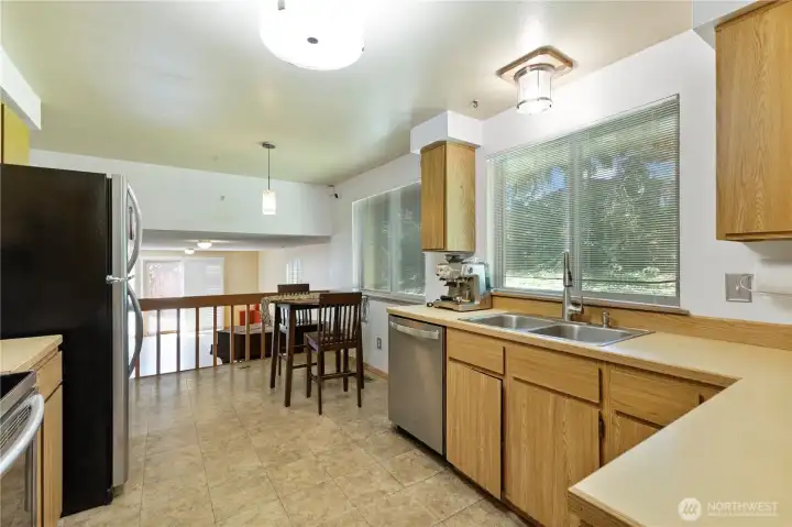 Area for a small casual breakfast table next to kitchen, kitchen/dinette is open to downstairs great room. Large window help bring in all the natural light making the space feel spacious