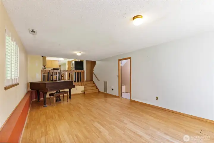 View of kitchen and minimal steps to main living space. The great room also connects to utility room, full bath and  a 4th bedroom
