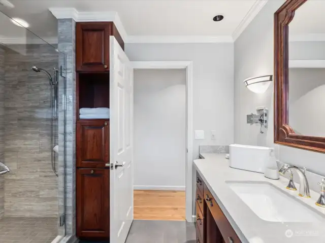 Main bathroom large walk in shower, quartz countertops, heated flooring, and cherry wood cabinets.