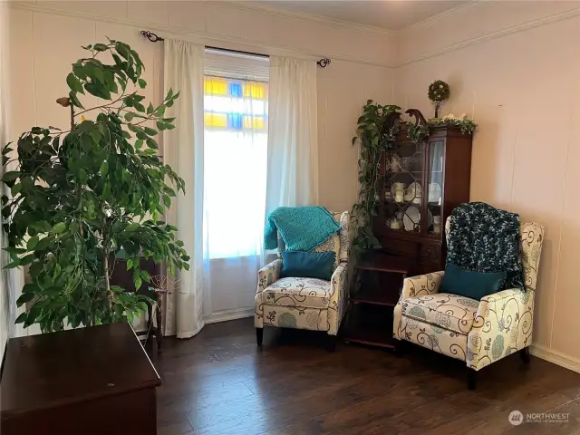 beautifully remodeled Victorian parlor, now a serene reading room, effortlessly combines historic charm with modern comfort.