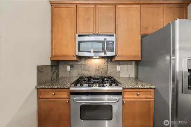 Gas stove is dreamy to cook on! Beautiful cabinetry offers good storage.