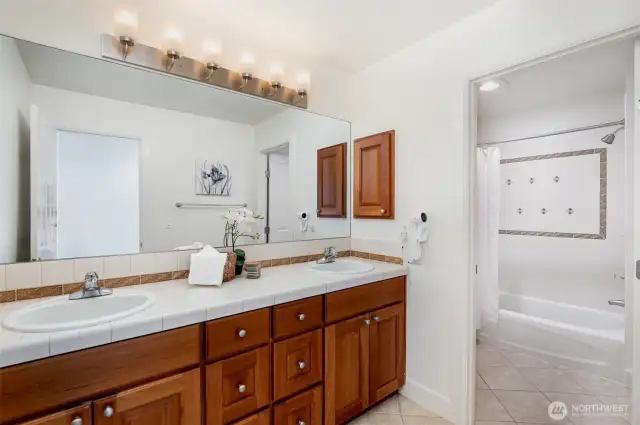Guest bath with dual vanities & separate tub/toilet room.