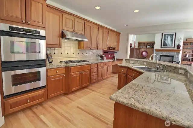 Stainless Steel Double oven, gas cooktop, slab granite and plenty of cabinets.