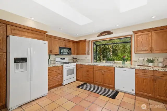 Open kitchen with garden window and 2 skylights bring in even more natural light