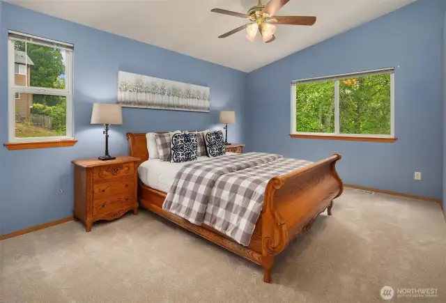 Primary bedroom with walk-in closet, vaulted ceiling and 3/4 ensuite bathroom.