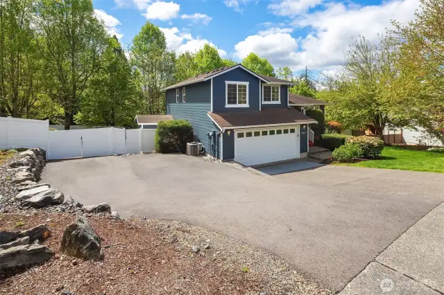 Additional paved parking on the side of the home.