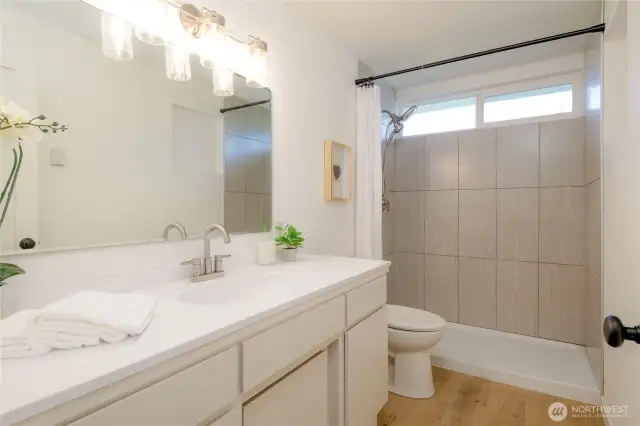 modern design main floor full bathroom w/ oversized vanity and new walk in tiled shower