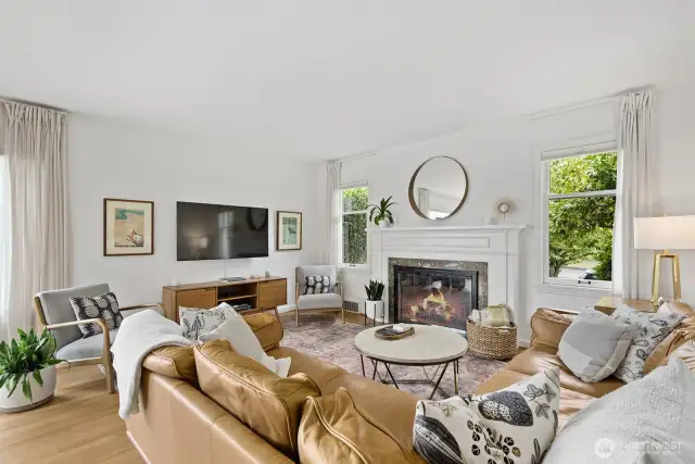 Cozy gas fireplace and lovely mantle center the room.