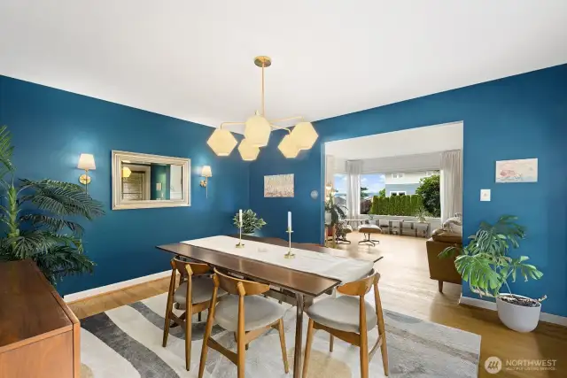 Spacious dining room  brought to life with stunning walls and brushed gold statement chandelier.